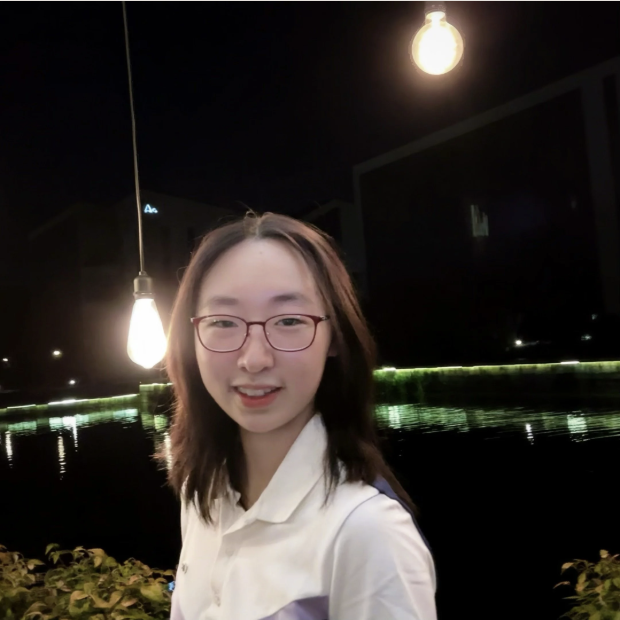 Yan Zhang by a lake at night